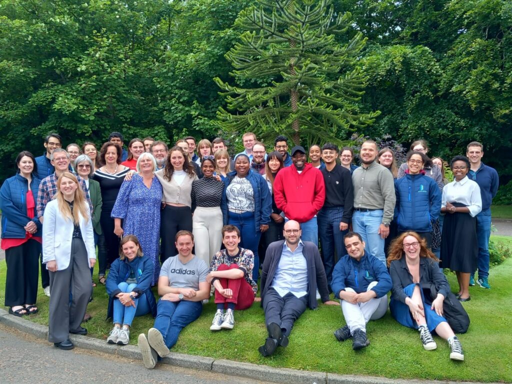 WIRe CDT PhD students and staff smiling for a group picture