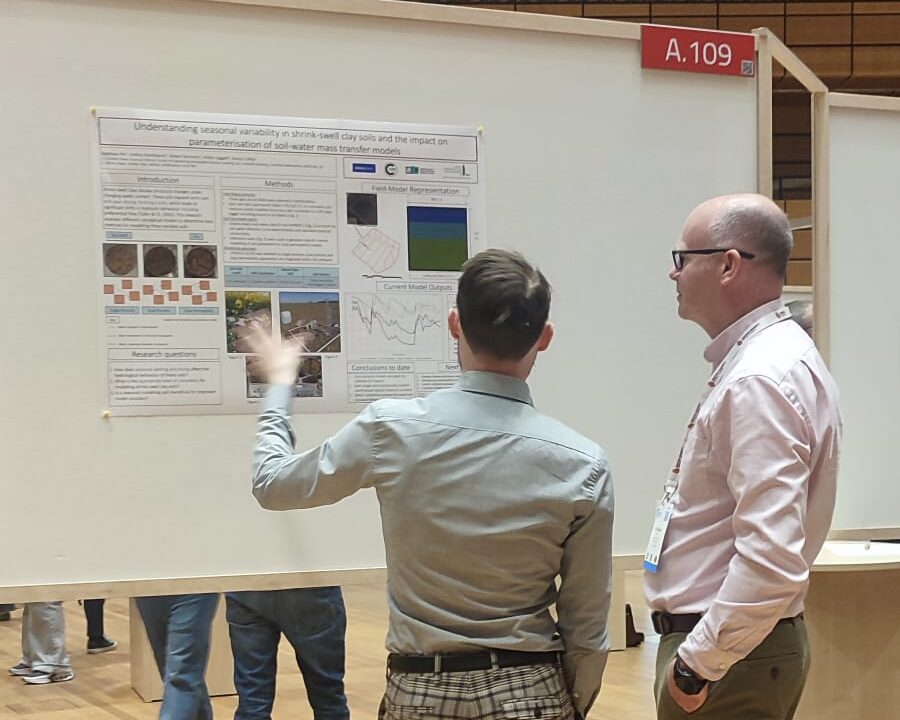 two academics discuss a scientific poster