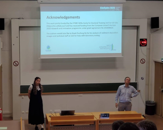 Kaeli and James delivering their conference presentation in a lecture theatre
