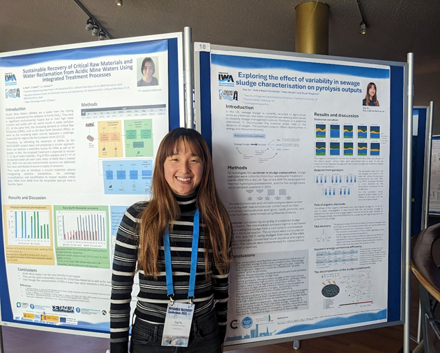 Siqi stands next to her scientific conference poster