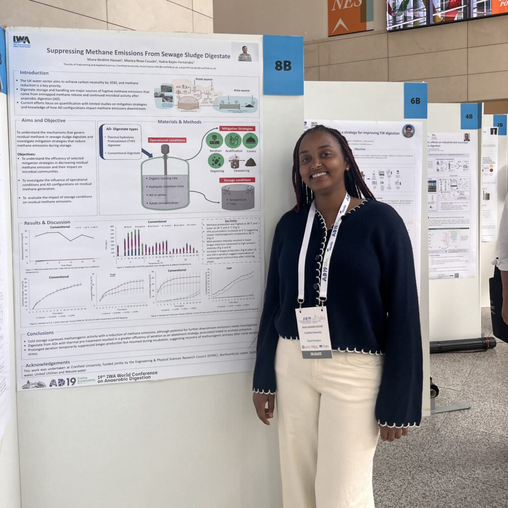 a woman stood next to a scientific poster