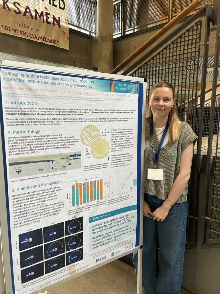 a woman stands next to a scientific poster