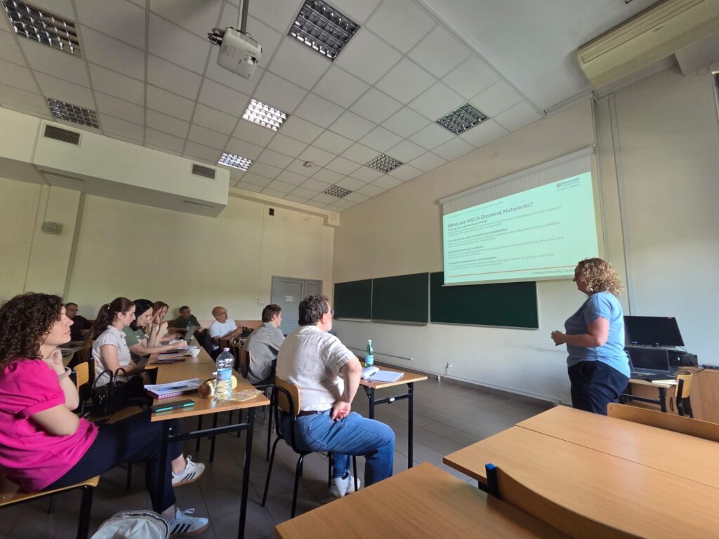 a woman presenting in front of a classroom of people