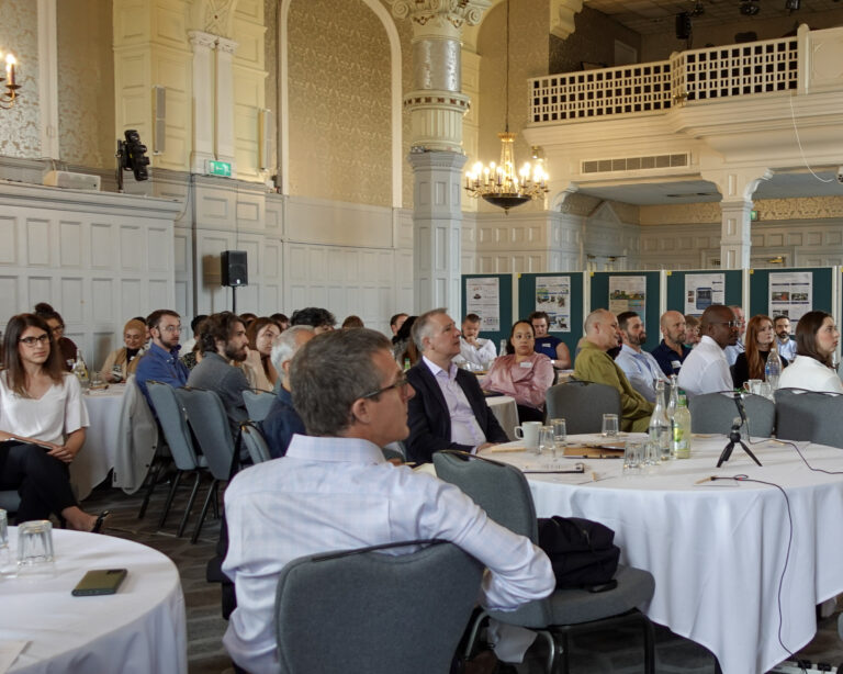 an audience of people sat at round tables