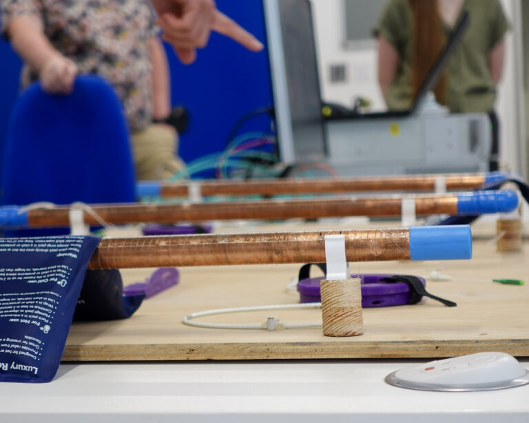 Fibre optic cables wrapped around a copper pipe