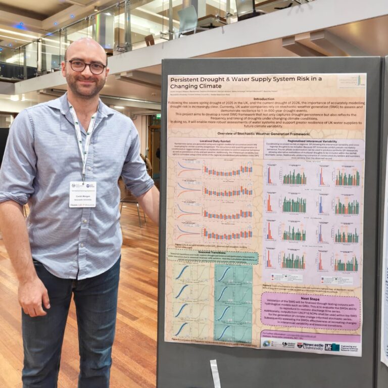 a man stands next to a scientific poster